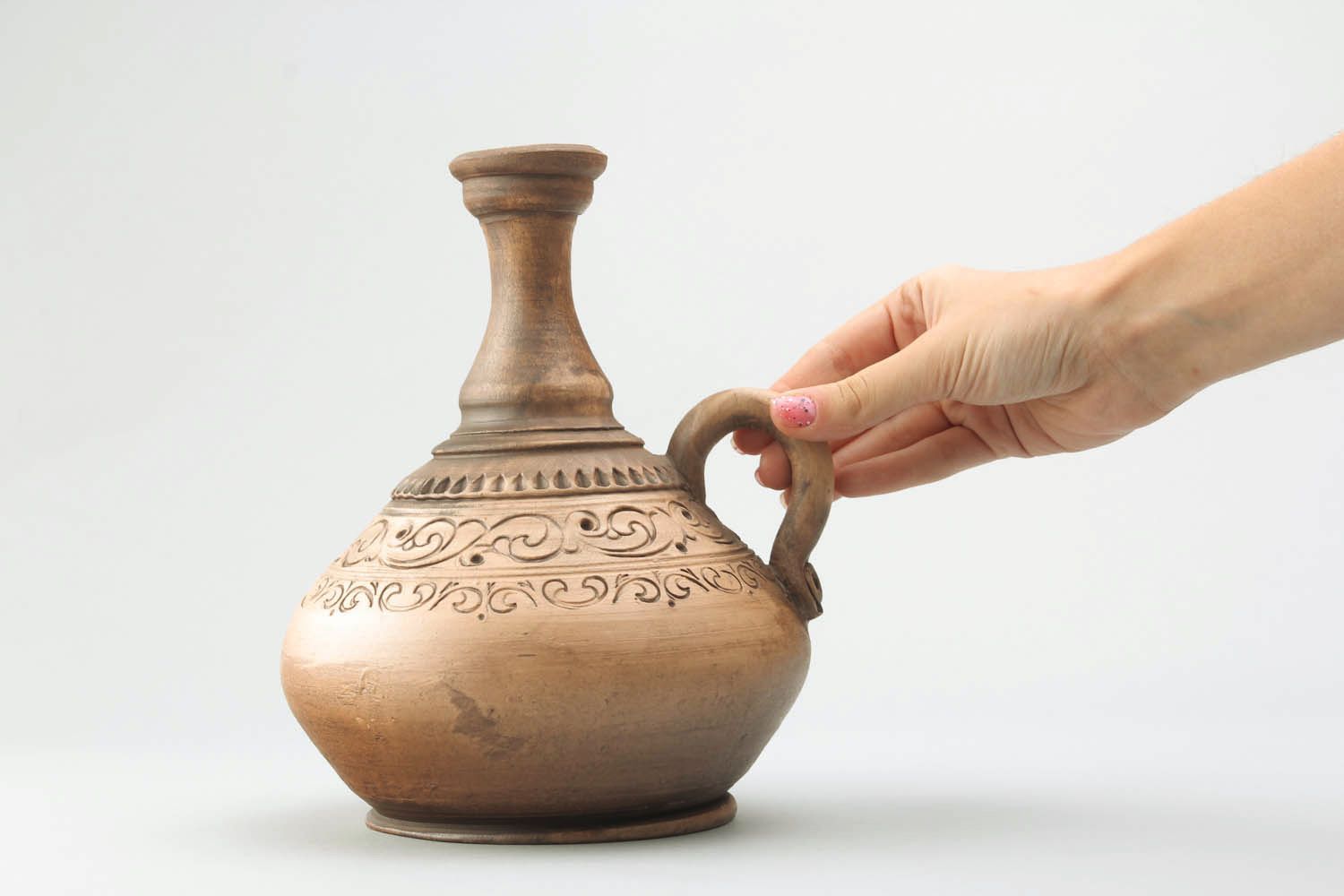 Ceramic wine jug with ornaments