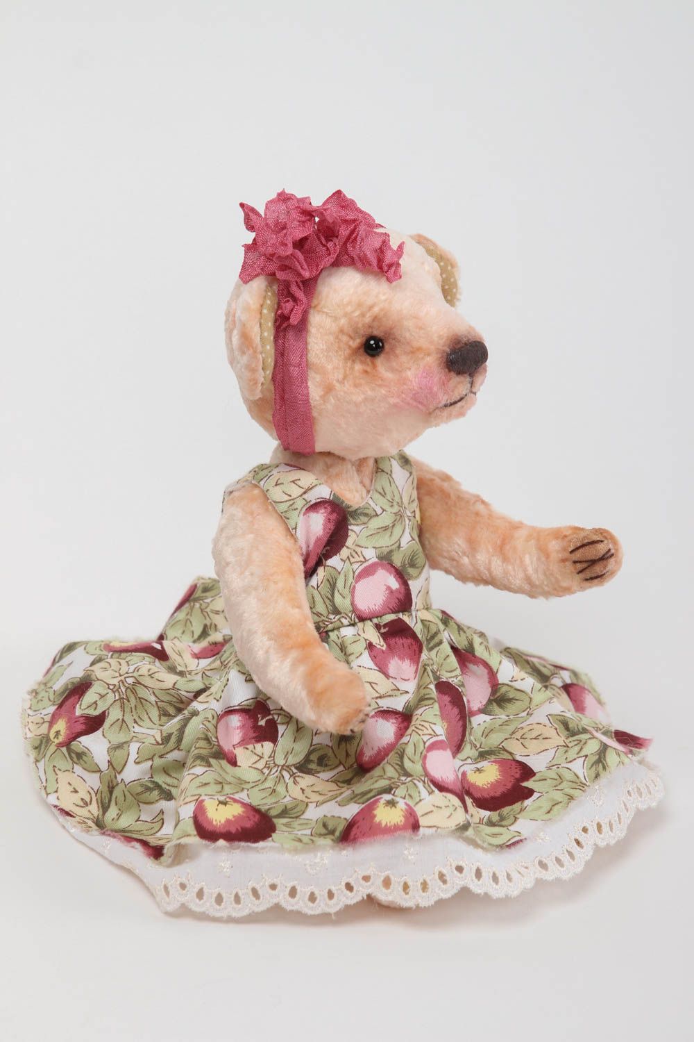 Vintage teddy bear in a dress .
