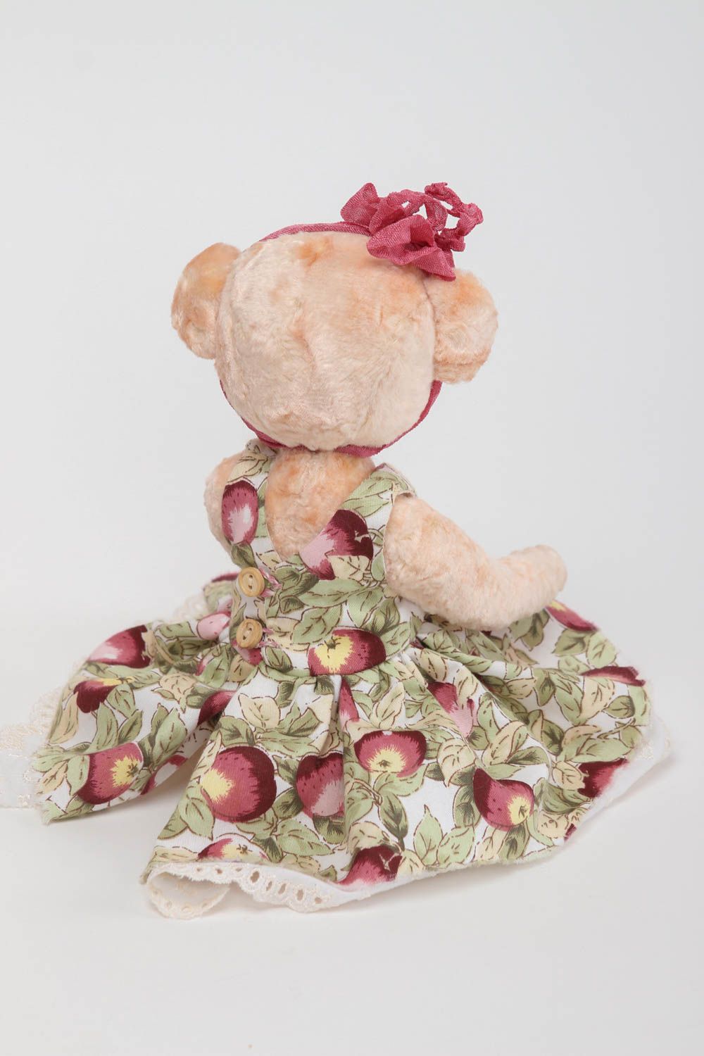 Vintage teddy bear in a dress .