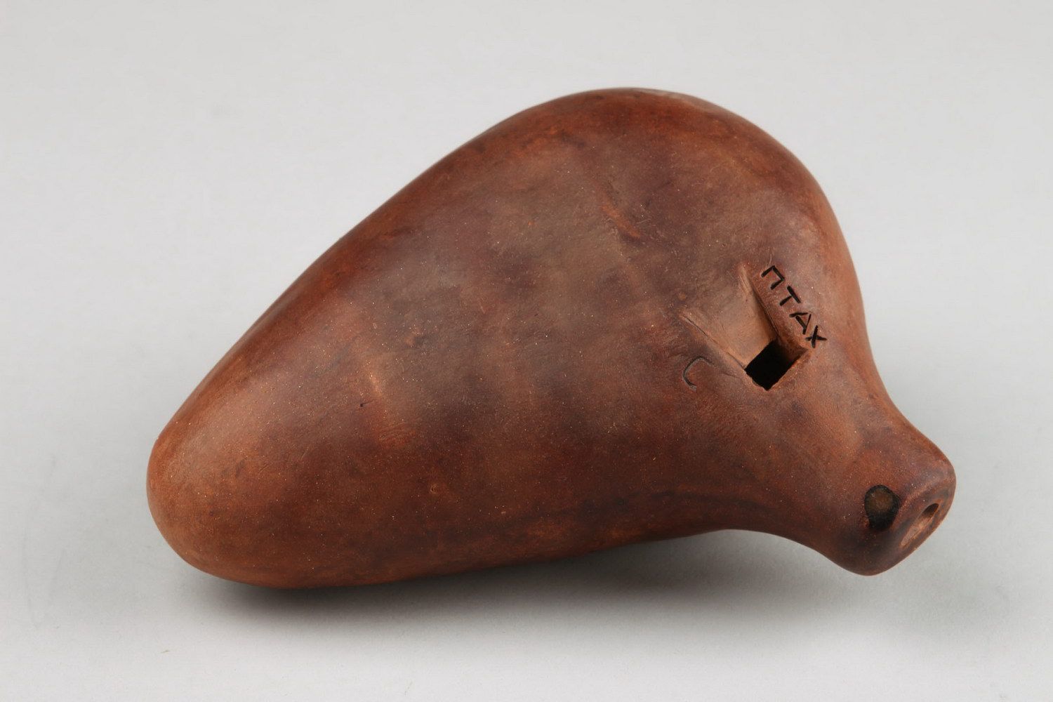 Ocarina, clay whistle flute with 8 holes.