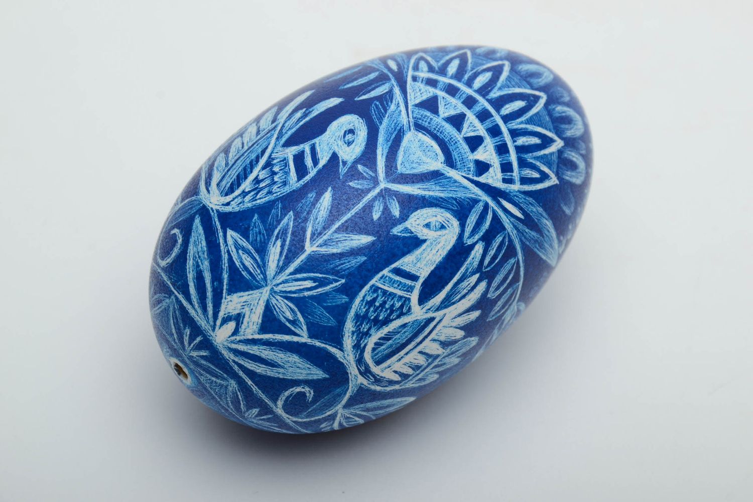 Painted goose egg in the technique of scratching.